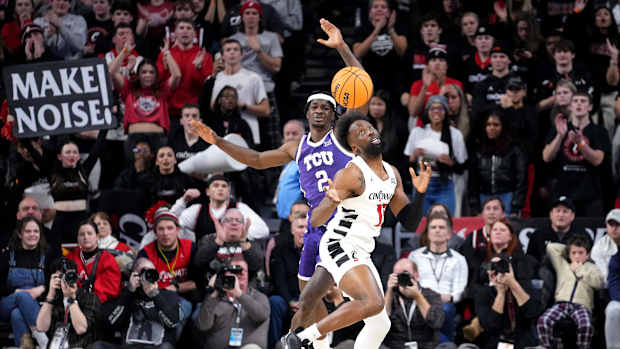 Cincinnati Bearcats forward John Newman III (15) steals the ball from TCU Horned Frogs forward Emanuel Miller (2) in the overtime period of a college basketball game between the TCU Horned Frogs and the Cincinnati Bearcats, Tuesday, Jan. 16, 2024, at Fifth Third Arena in Cincinnati. The Cincinnati Bearcats won, 81-77.
